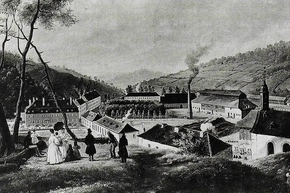 Gravure ancienne de 1836 représentant la verrerie de Saint-Louis-lès-Bitche dans une vallée boisée, avec ses bâtiments industriels et ses cheminées